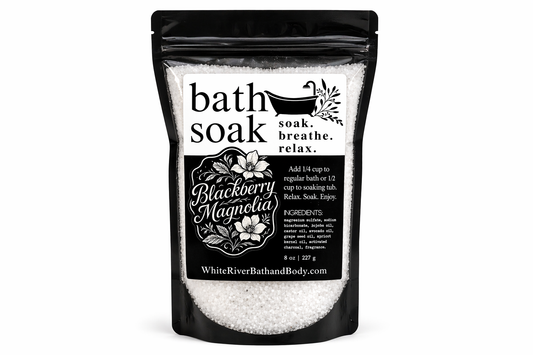 Black and white packaging of bath soak with branding and product details.