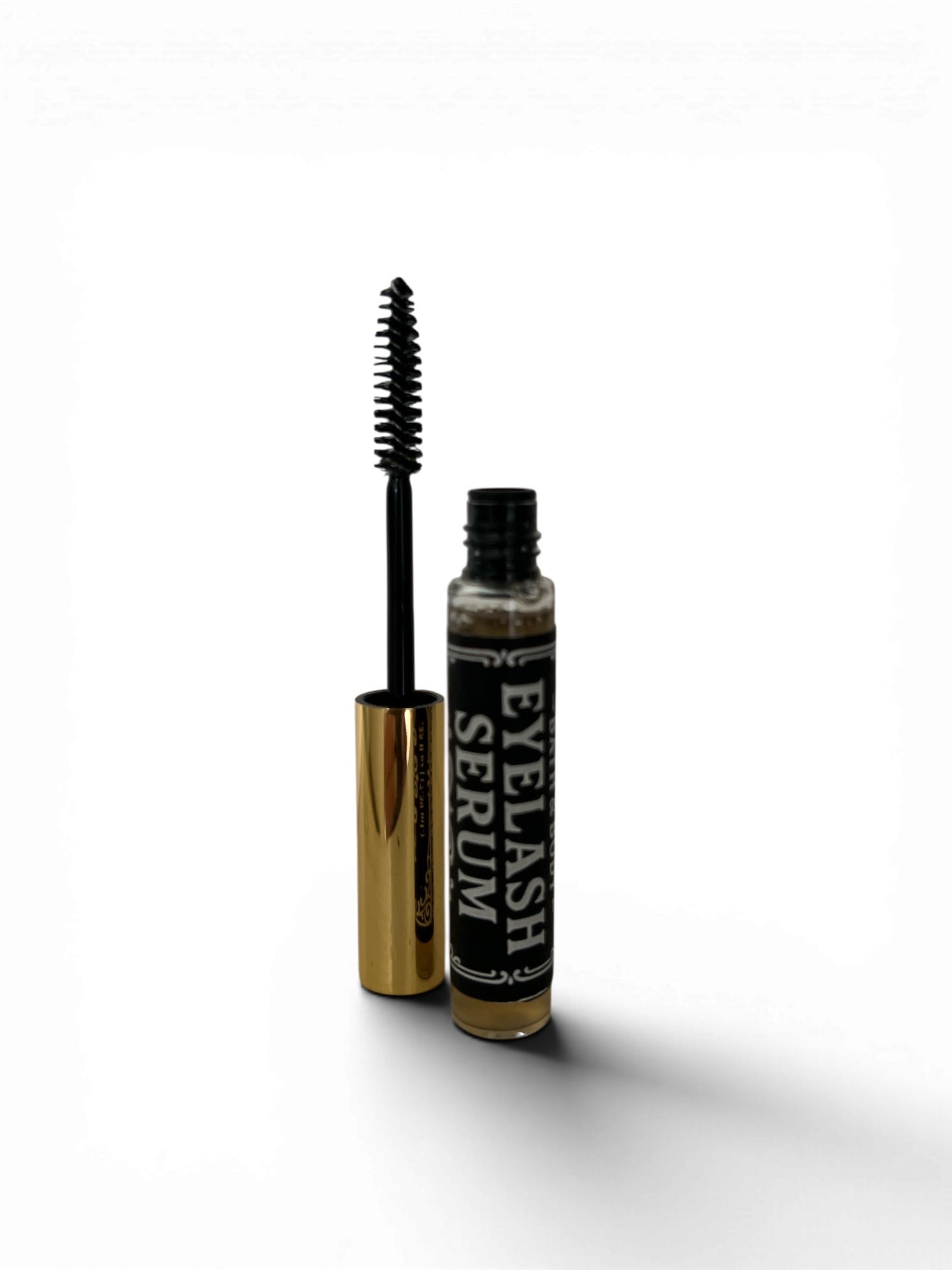 Eyelash serum with applicator on a white background