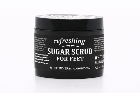 Jar of refreshing sugar scrub for feet on a white background