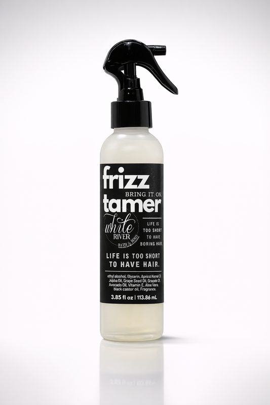Bottle of frizz tamer with black and white label on a white background