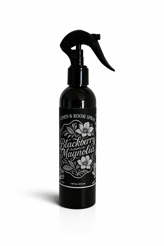 Black bottle with a sprayer labeled 'Blackberry Magnolia' on a white background