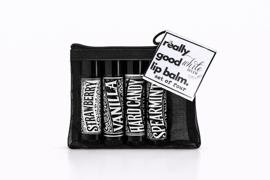 Set of four lip balms in a black pouch with a 'really good' lip balm tag.
